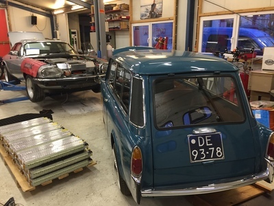 Car workshop showing a Jaguar and a Mini